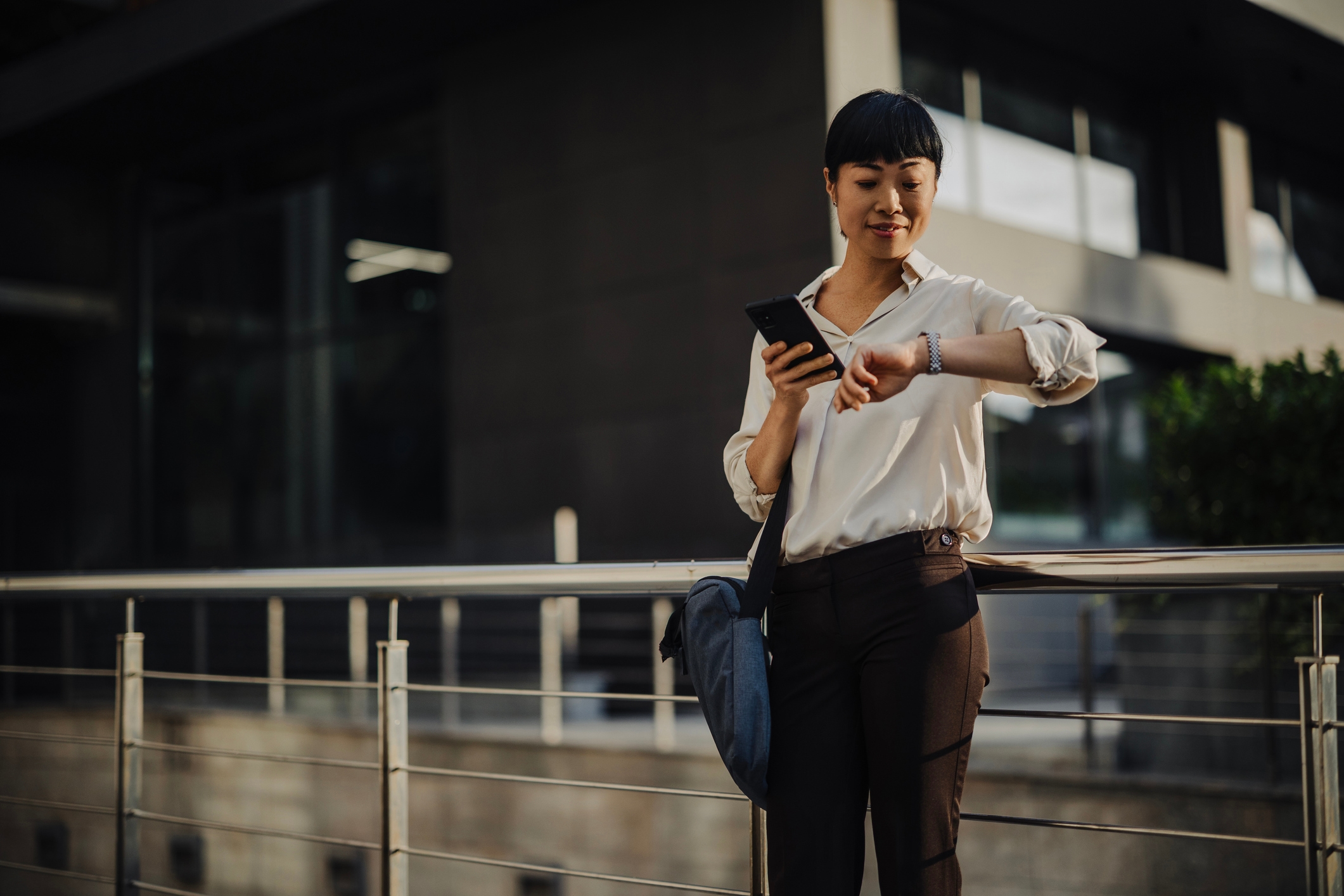 japanese businesswoman using smartphone while commuting to work
